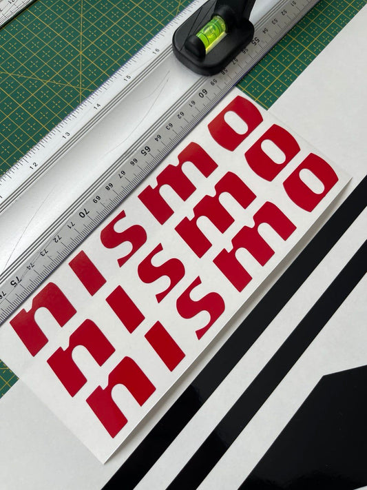 A close-up view of a red and white vinyl sticker with the text 'NISSED' designed for compatibility with Nissan Z cars.
